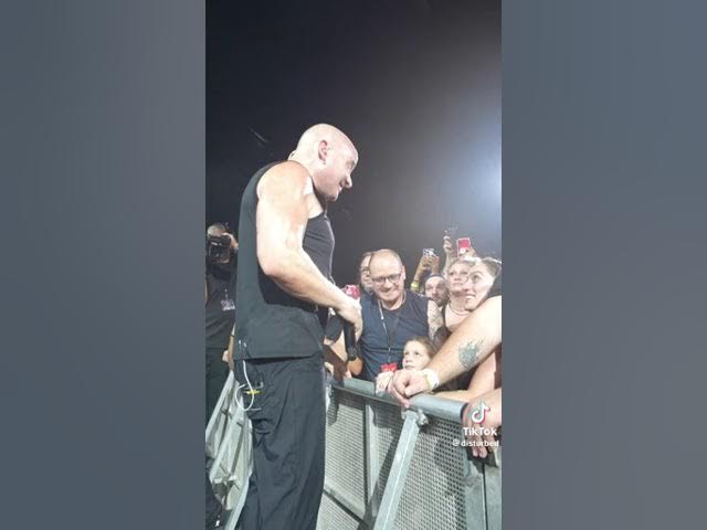 Disturbed stops show to comfort scared girl background