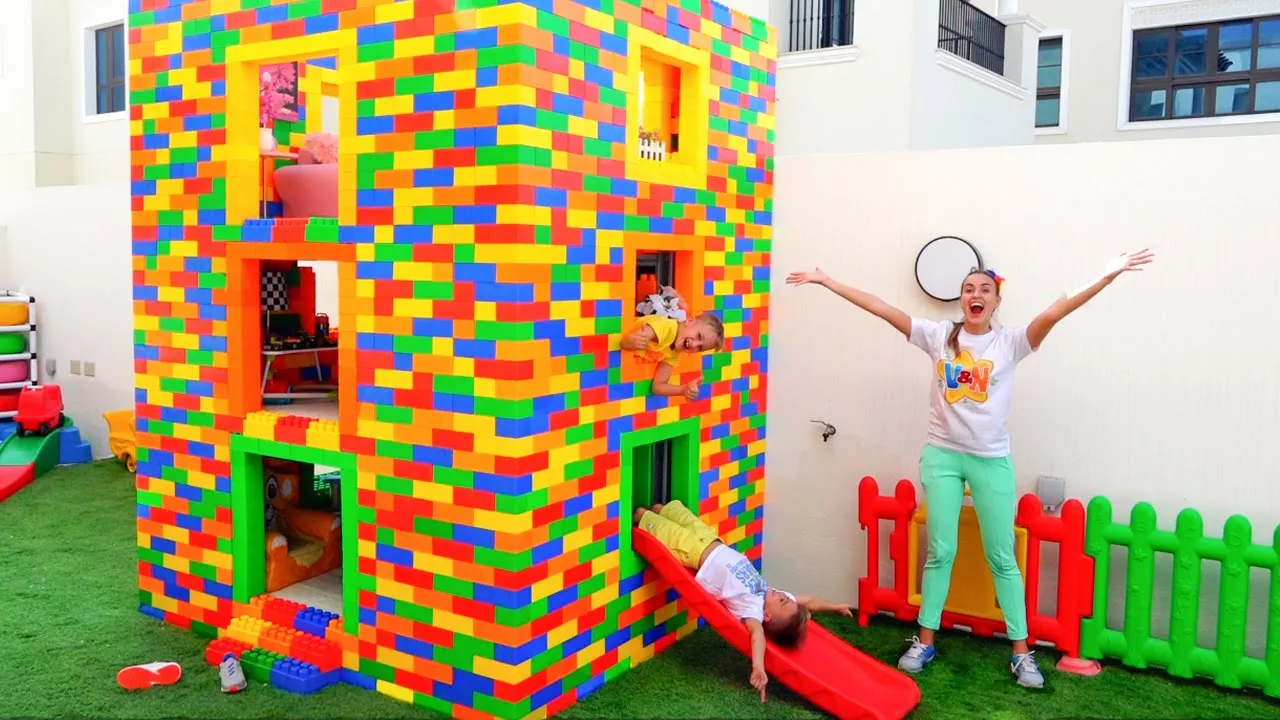 Vlad and Niki play with colored toy blocks and build Three Level House background
