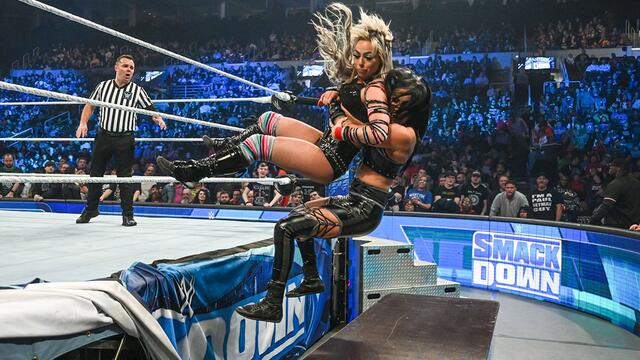 Liv Morgan and Sonya Deville crash through a table