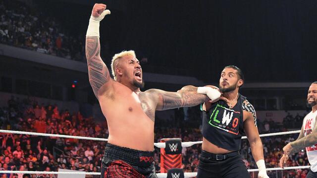 The Bloodline take out Rey Mysterio and the LWO background
