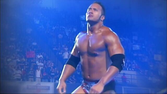 The Rock battles Triple H in SmackDown debut background