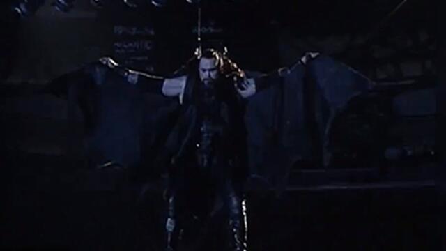 The Undertaker makes a bat-like descent into Survivor Series 1996 background