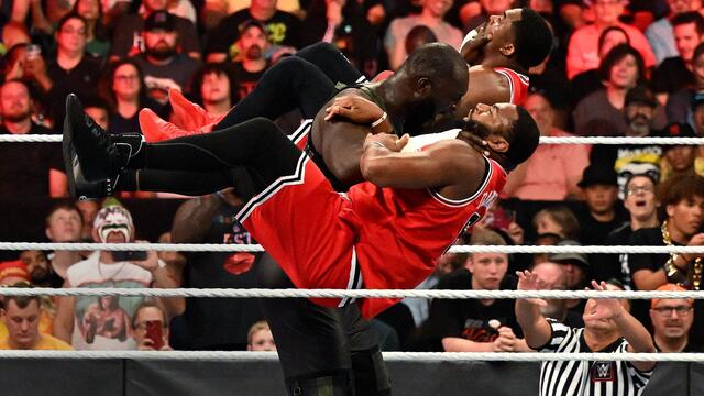Omos plants The Street Profits with a Double Chokeslam