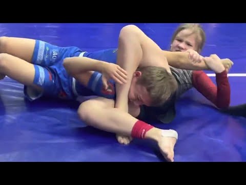 girl vs boy bjj 2023 - aleksandra yurkova submission by reverse triangle and armbar background
