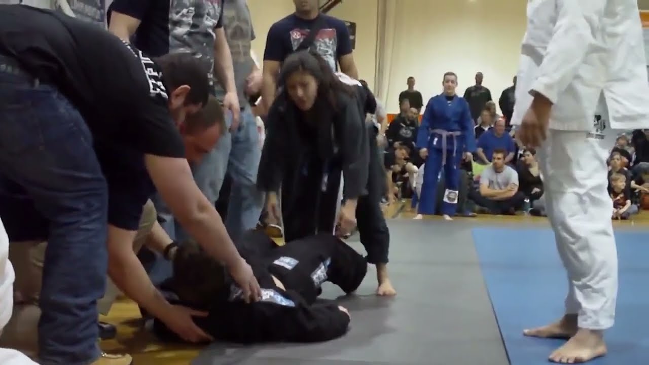 BJJ Girl chokes Unconscious guy. background