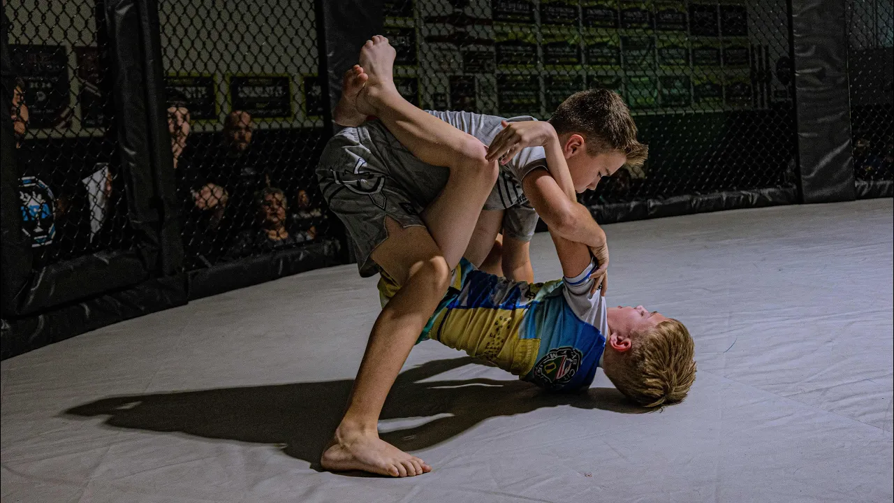 3 rounds of cage grappling. Youth match. background
