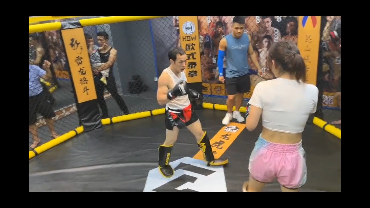 Bruce Lee Imitator Challenges Muay Thai Girl background