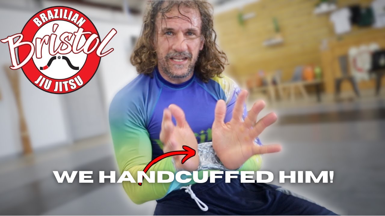 handcuffed BLACK BELT runs gauntlet backdrop