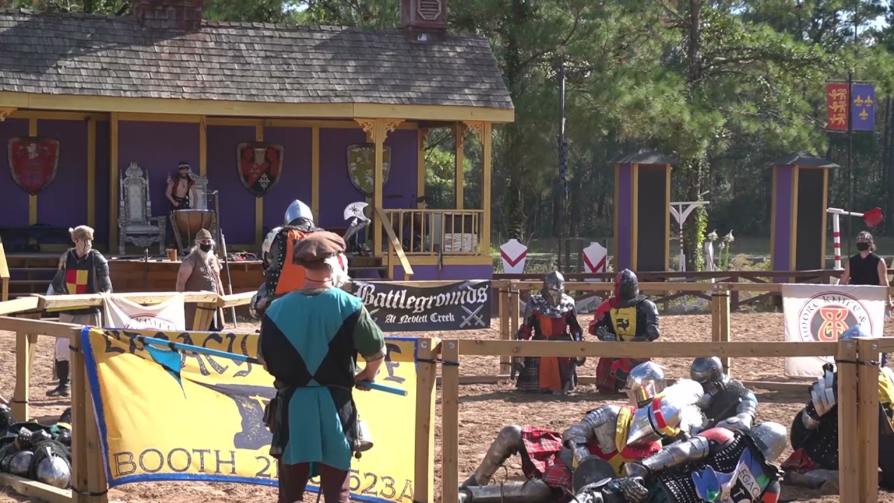 Knight with axe crushed by 7'1" 500lbs Giant at the Texas Renn Fair. background