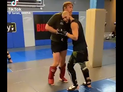 Gustafson Effortlessly Taking Khamzat Chimaev Down background