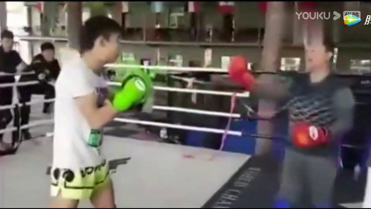 Tai Chi Hobbyist Challenges Kickboxer In The Ring background