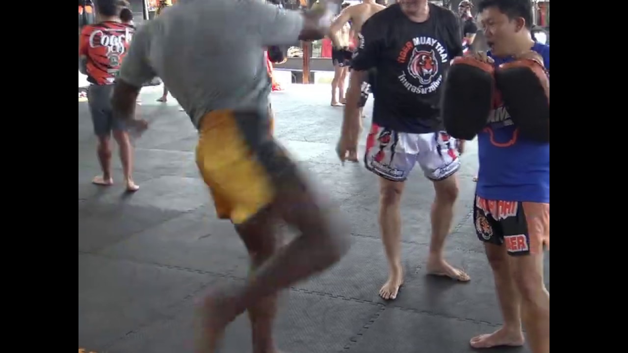 Khalil Rountree kicking at Samart Payakaroon & Dieselnoi Chor.Thansaukarn seminar background