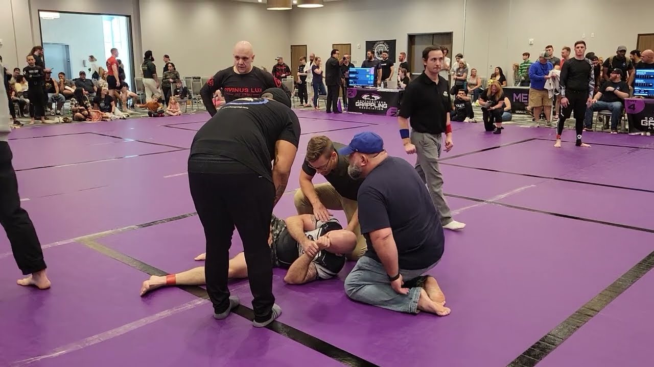 Injury during No Gi BJJ Grappling match. Holy City Sub Series 2023 background