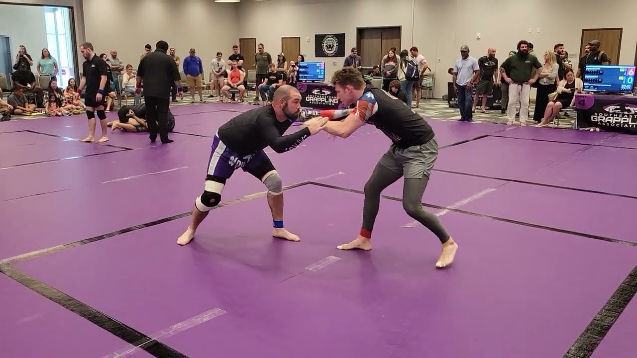 Low Elbow Guillotine finish in BJJ no gi match at Holy City Sub Series March 2023 backdrop