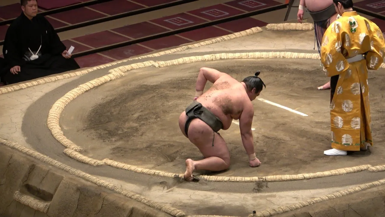 Sumo to draw up concussion rules after in-ring farce background