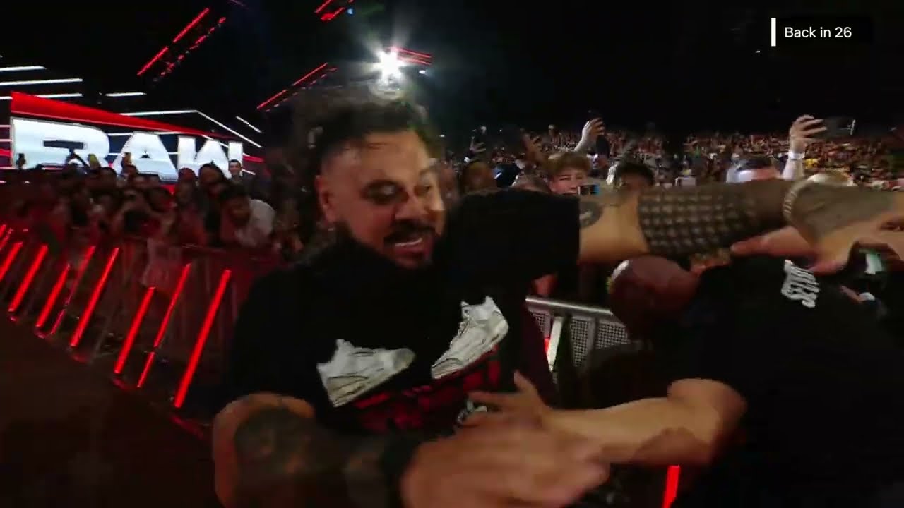Roman Reigns and Bronson Reed punches up the aisle as they go to the back | Raw Aug 25, 2025 background