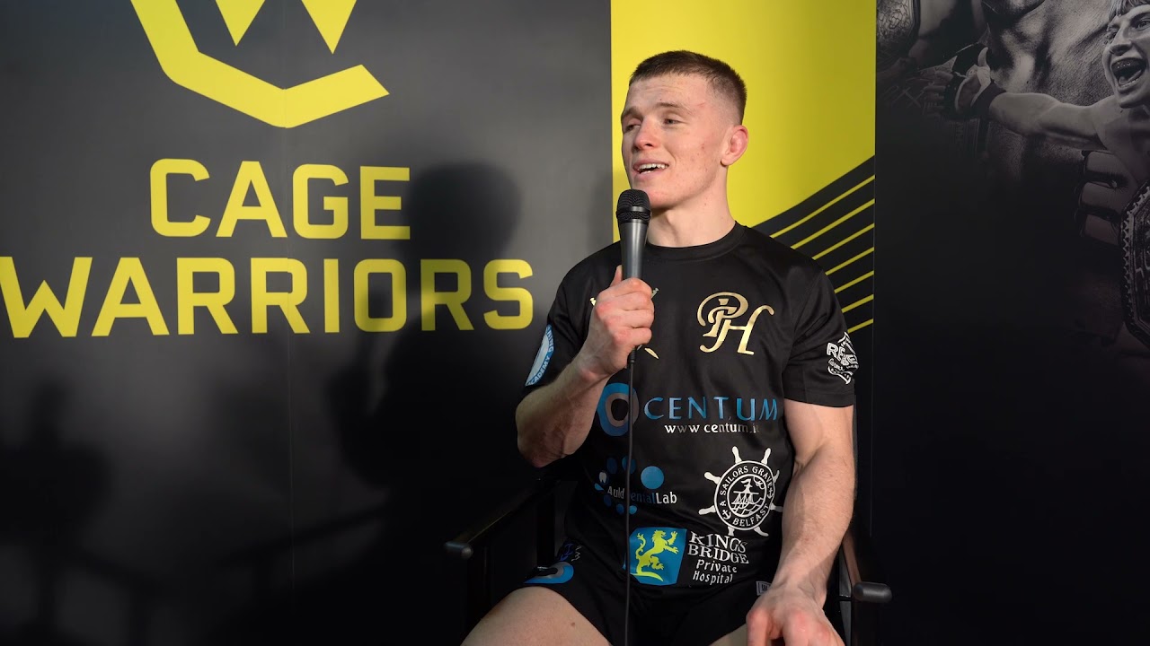 Edith Labelle speaks to Paul Hughes following his win at CW120 background