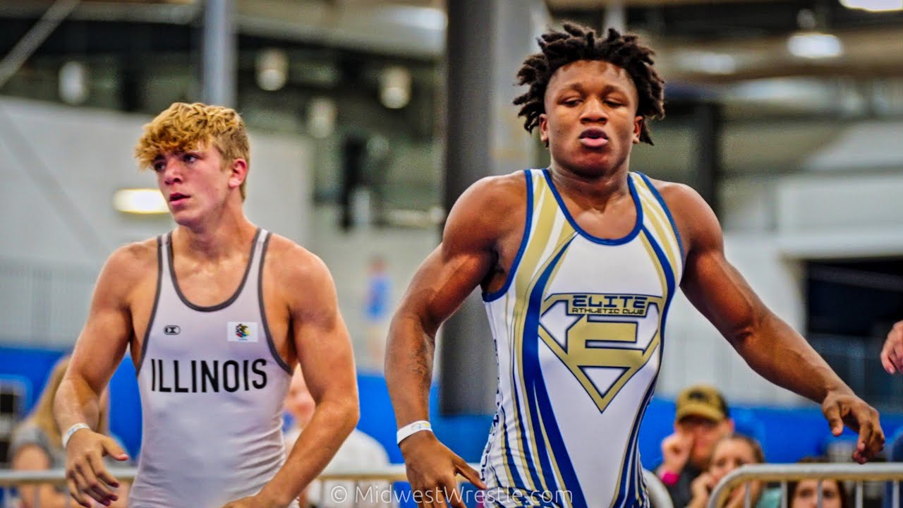 138 – Dom Serio {G} of Team Gotcha West IL vs. Pierre Baldwin {R} of Elite Athletic Club IN background