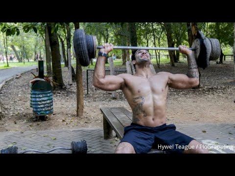 Leandro Lo's Strength Workout In An Outdoor Primitive Gym background