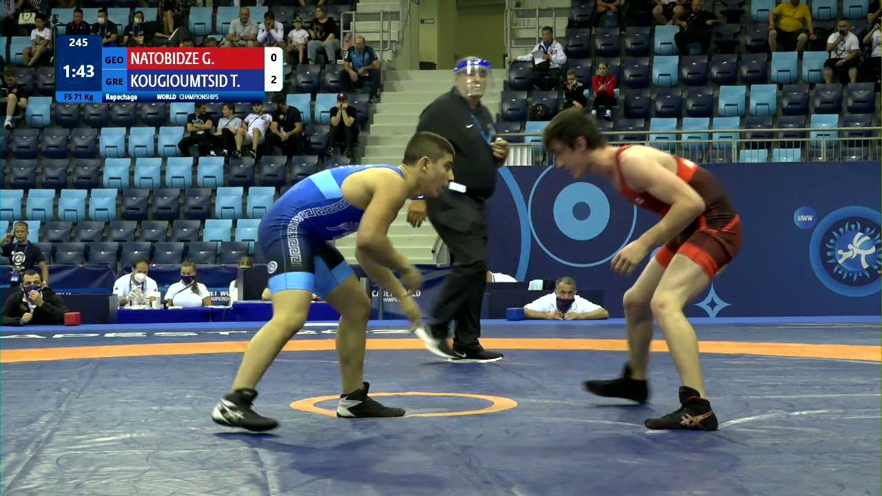 Repechage FS - 71 kg: G. NATOBIDZE (GEO) v. T. KOUGIOUMTSID (GRE) background