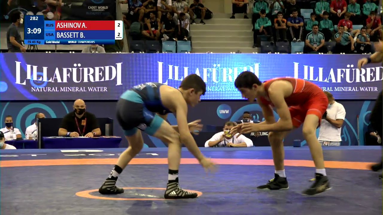 GOLD FS - 45 kg: A. ASHINOV (RUS) v. B. BASSETT (USA) background