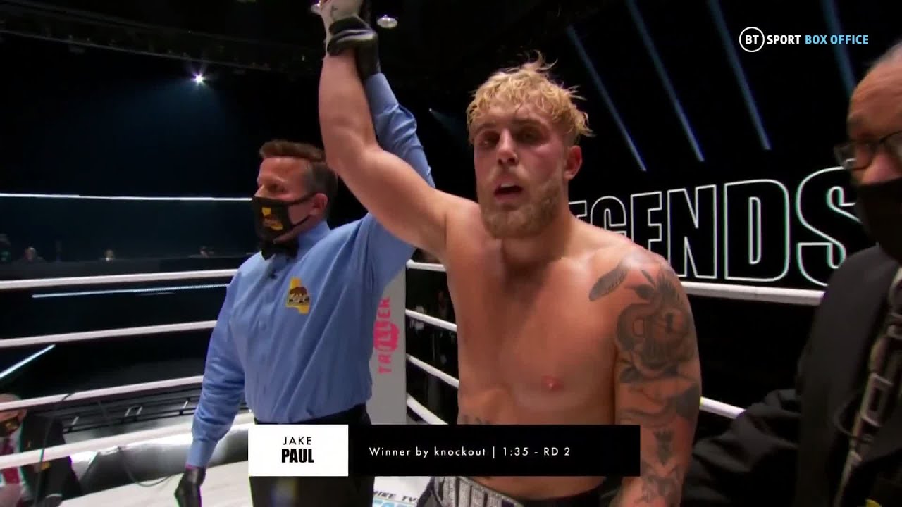 Jake Paul celebrates after knocking out Nate Robinson on the Tyson v Jones undercard background