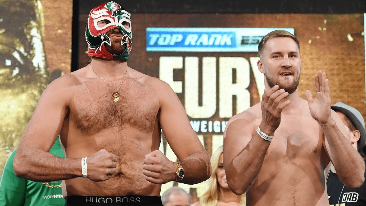 "Get the steel cage out!" Tyson Fury and Otto Wallin exchange words on stage during face off background