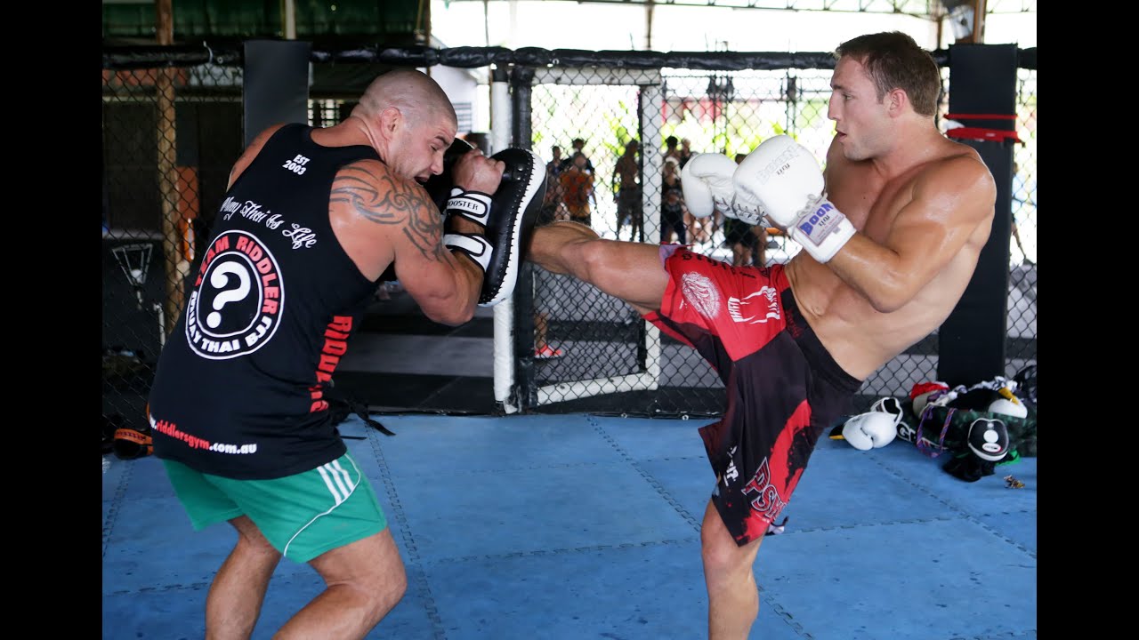 Brad "Quake" Riddell Hitting Pads for Global Fighting Championship background