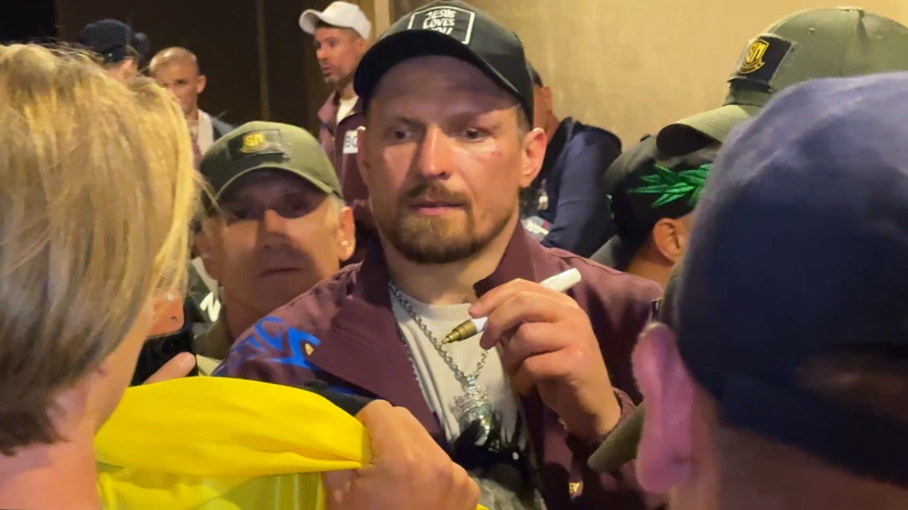 RESPECT: Oleksandr Usyk TAKES TIME to sign gloves for fans