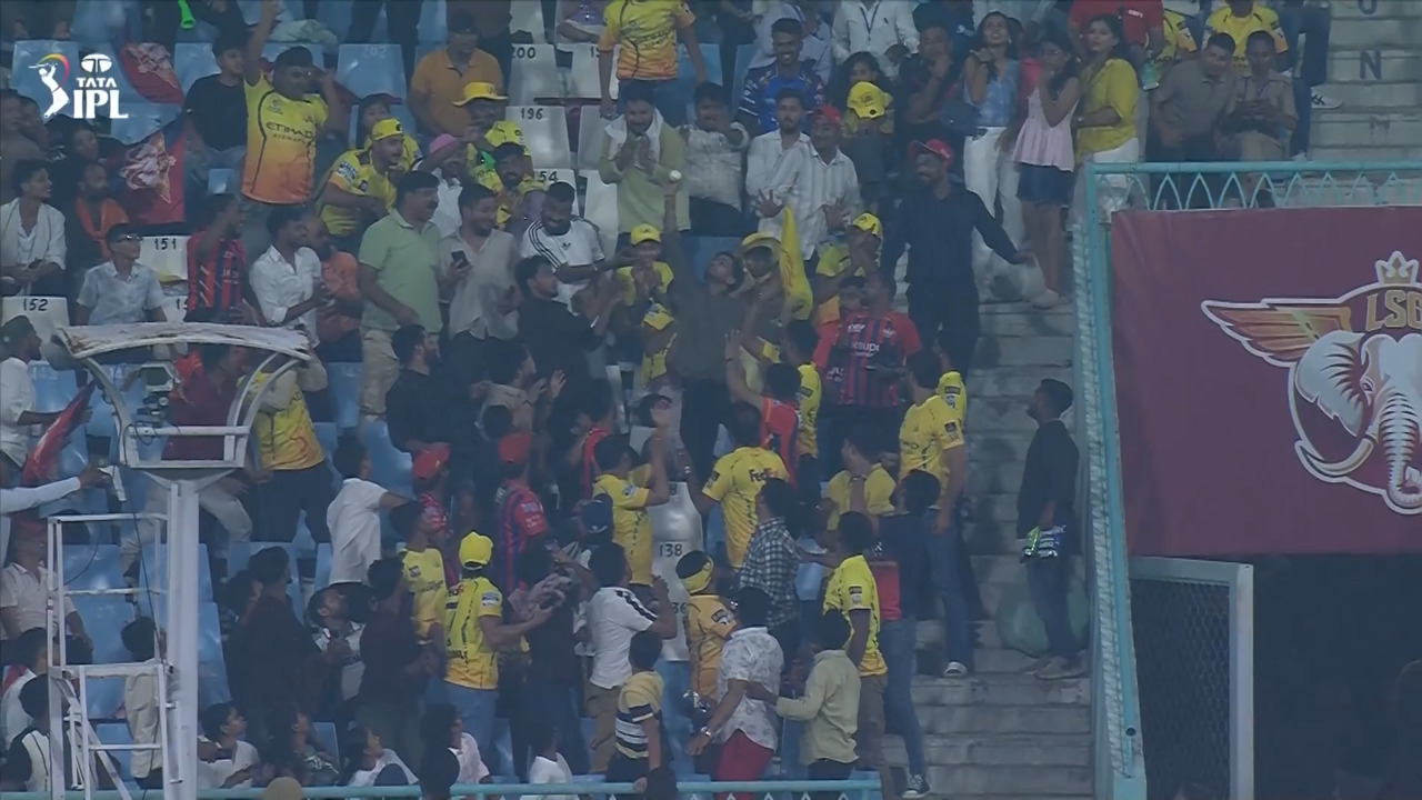 Fan-tastic! An unbelievable one-handed stunner in the crowd background