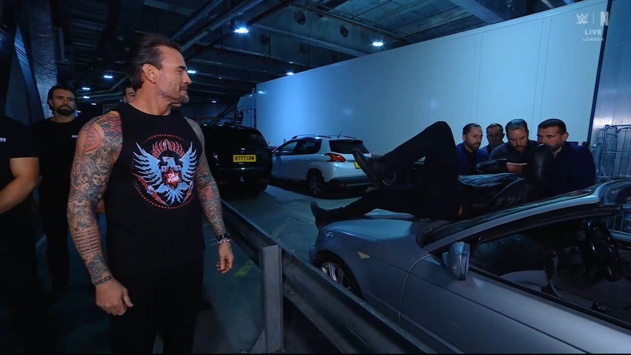 CM Punk amused watching Drew McIntyre in pain after Damian Priest's brutal attack background